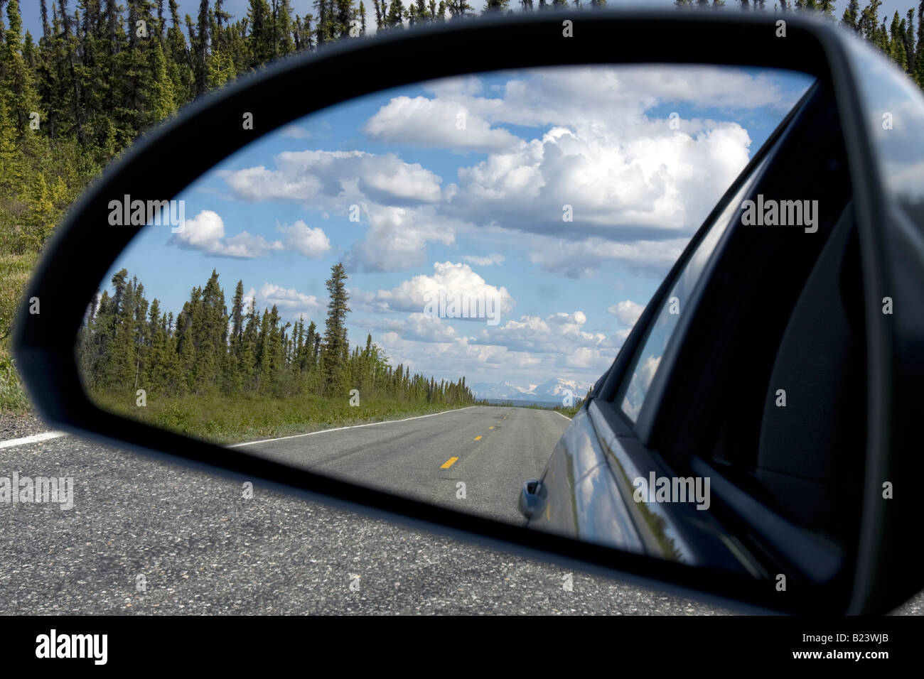 Long empty road in the car mirror, Alaska Stock Photo