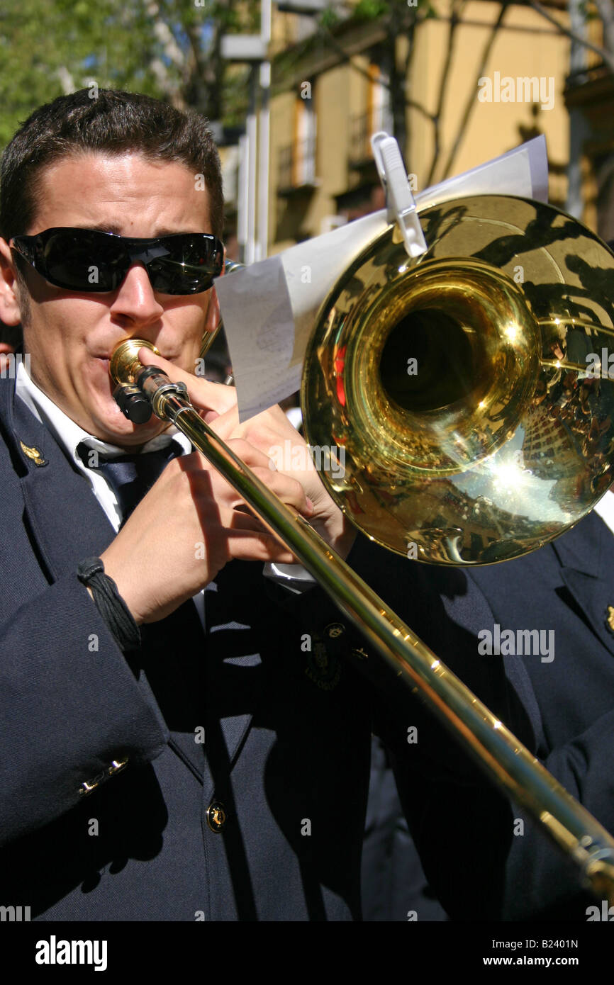 man blowing a trombone, semana santa procession, seville, spain Stock