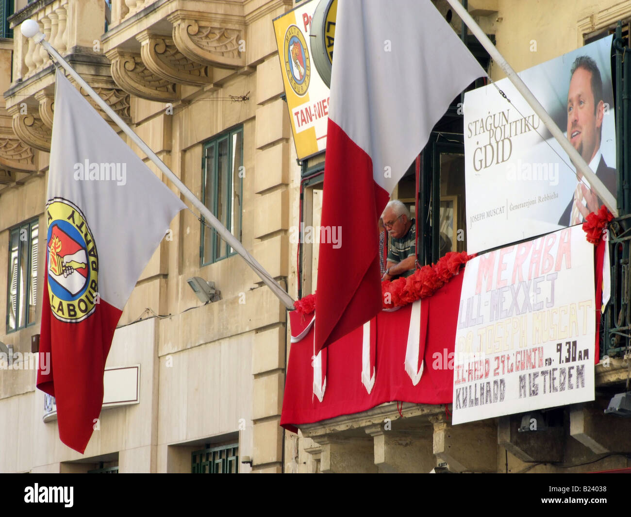 Flags and posters flanking the adorned balcony of the Maltese Labour