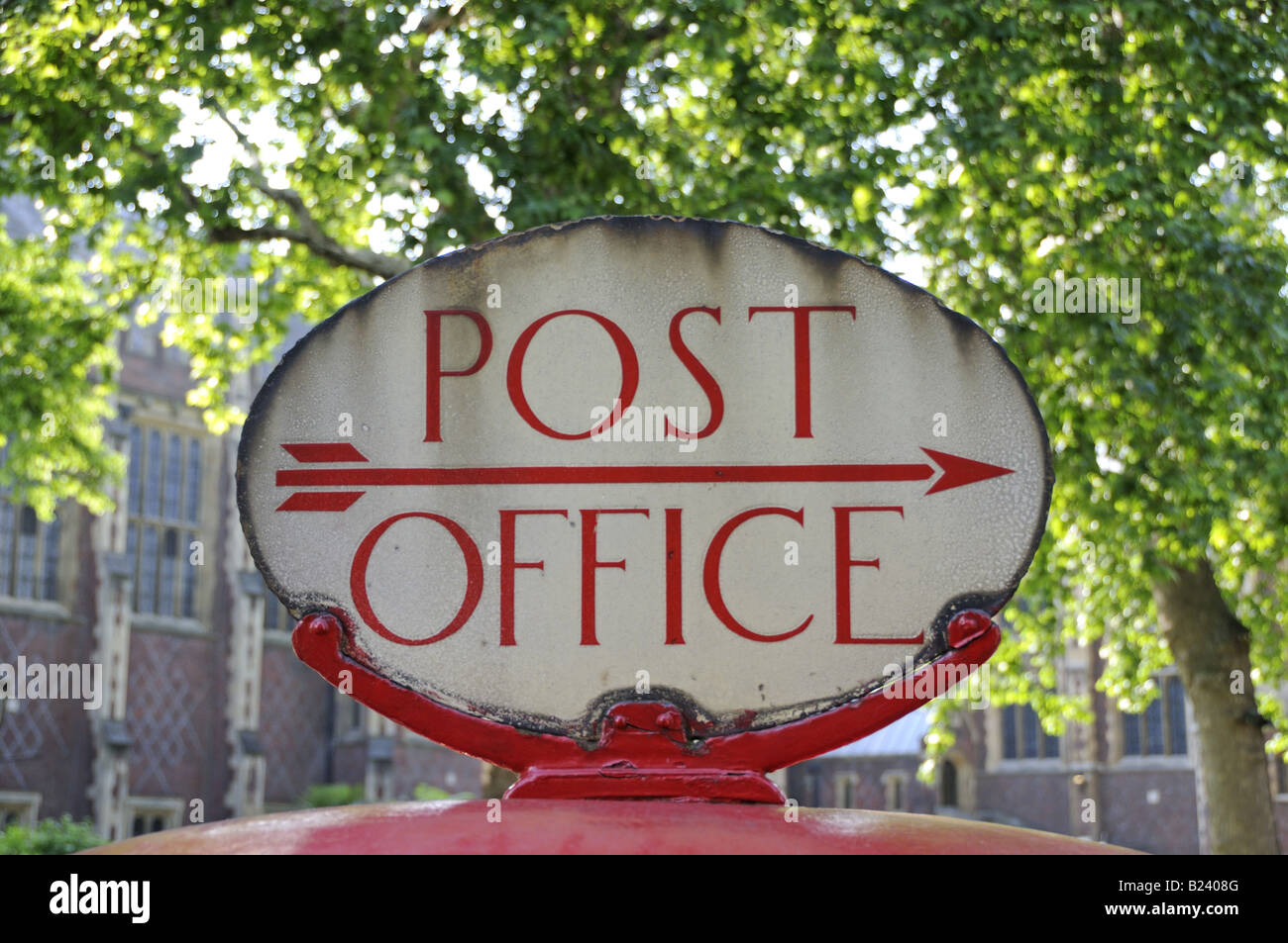 Distressed Post Office direction sign on top of Post Box London England UK Stock Photo
