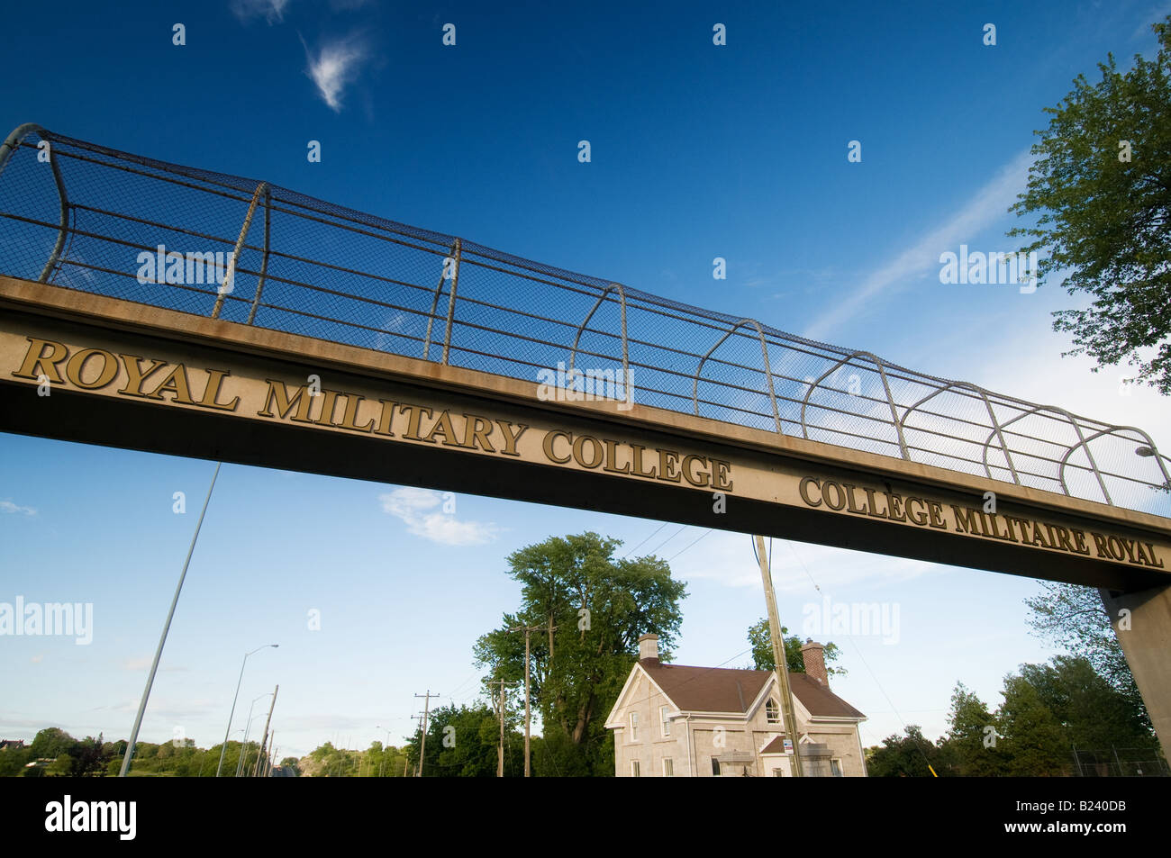 The Royal Military College sign in Kingston, Ontario, Canada, serves as a landmark and a pedestrian bridge. Stock Photo