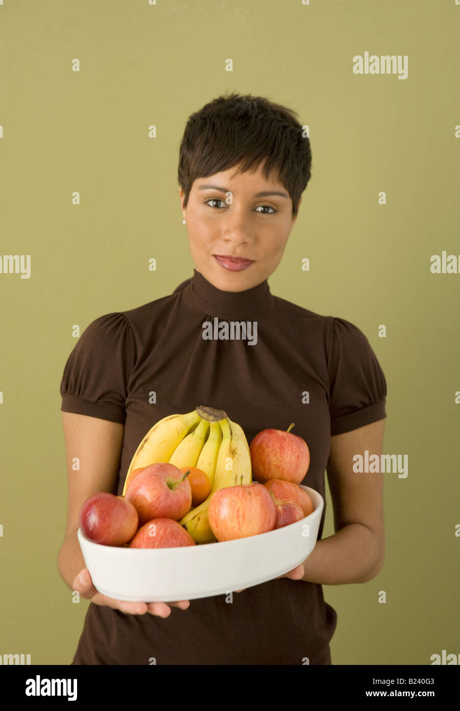 woman holds bowl of fresh fruit Stock Photo