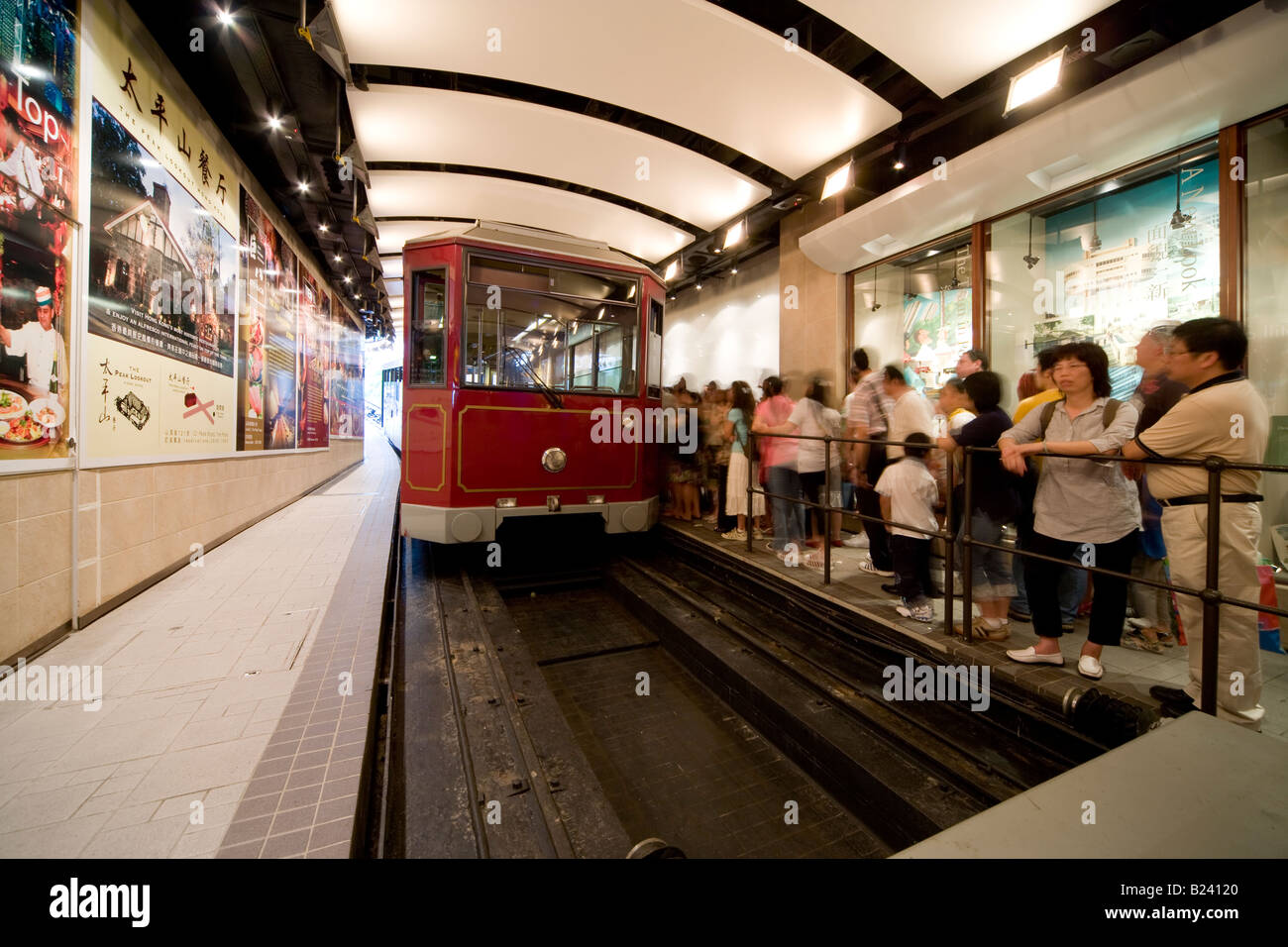 Passengers boarding the Victoria Peak Tram at its lower terminus station in Hong Kong, China SAR. Stock Photo