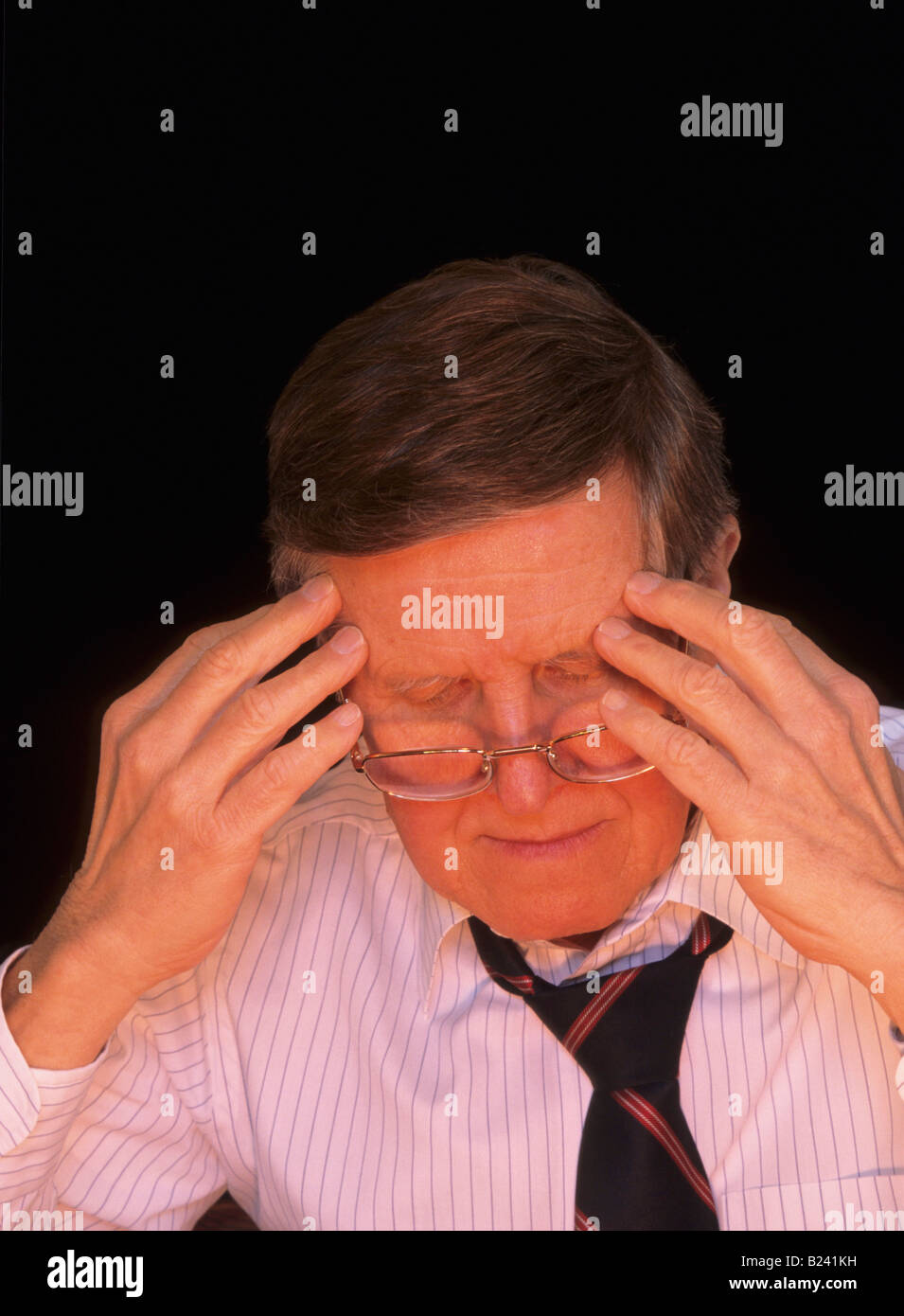 MAN WITH HEADACHE SHOWING STRESS OR FATIGUE Stock Photo
