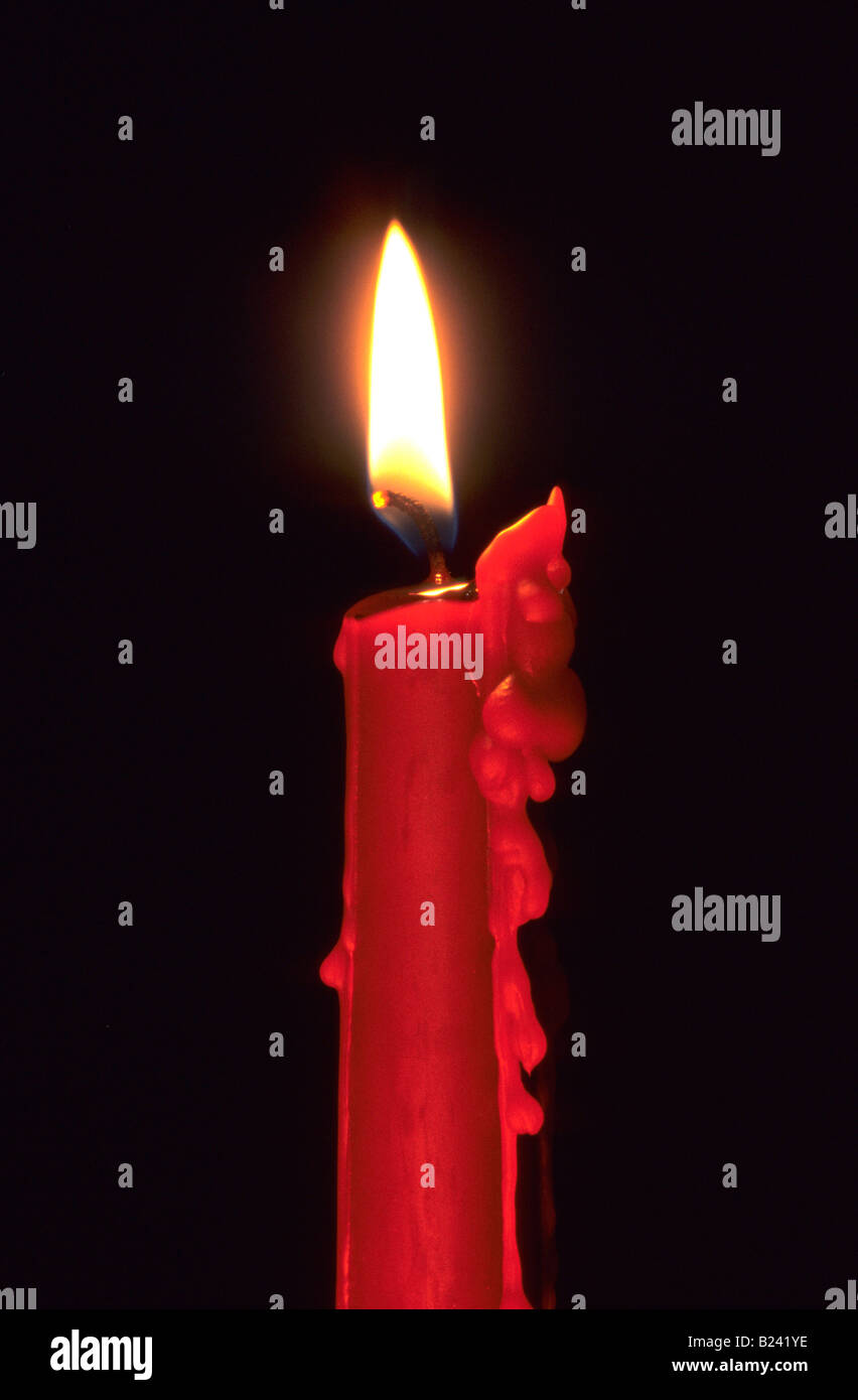 DRIPPING CANDLE WITH A BLACK BACKGROUND BURNING CANDLE RED AMBIENCE WAX BURN Stock Photo Alamy