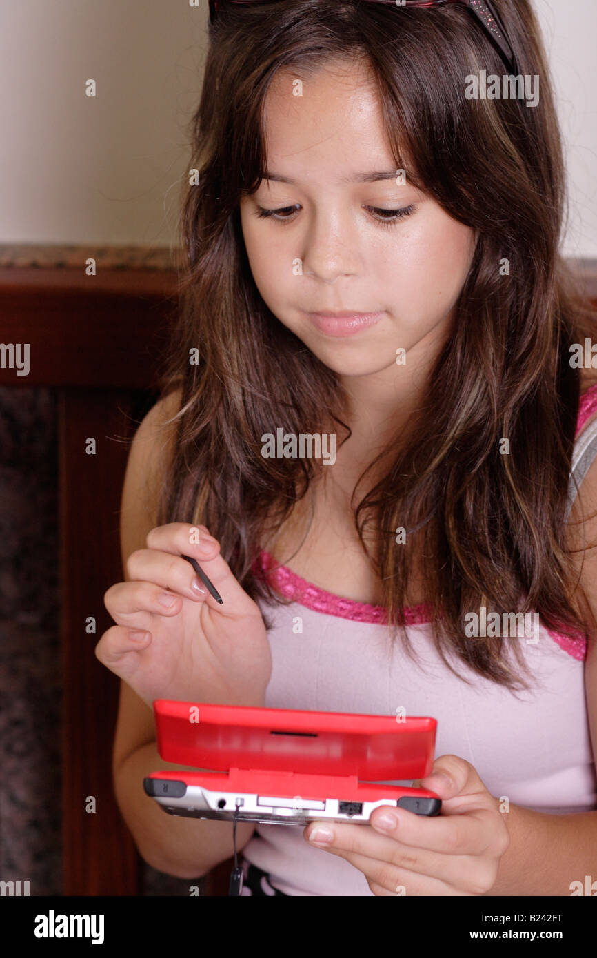 Stock Photograph of a teen girl using a handheld electronic device Stock Photo