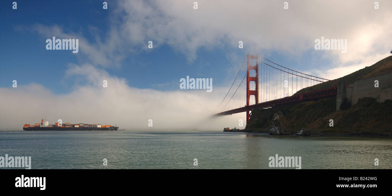 Cargo ship with containers stacked high on deck approaches Golden Gate ...
