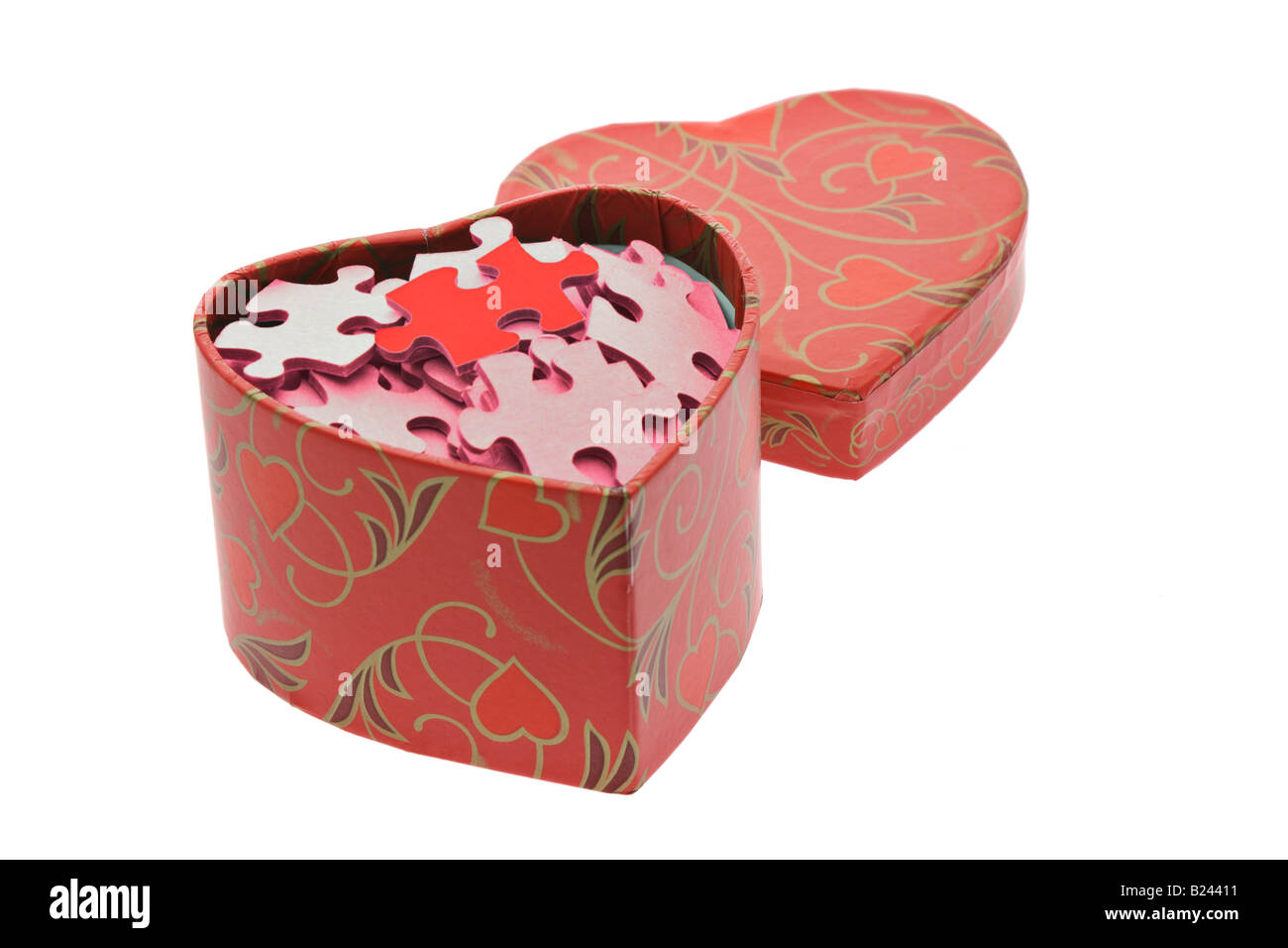 Red and pink jigsaw puzzles in heart shape gift box on white background
