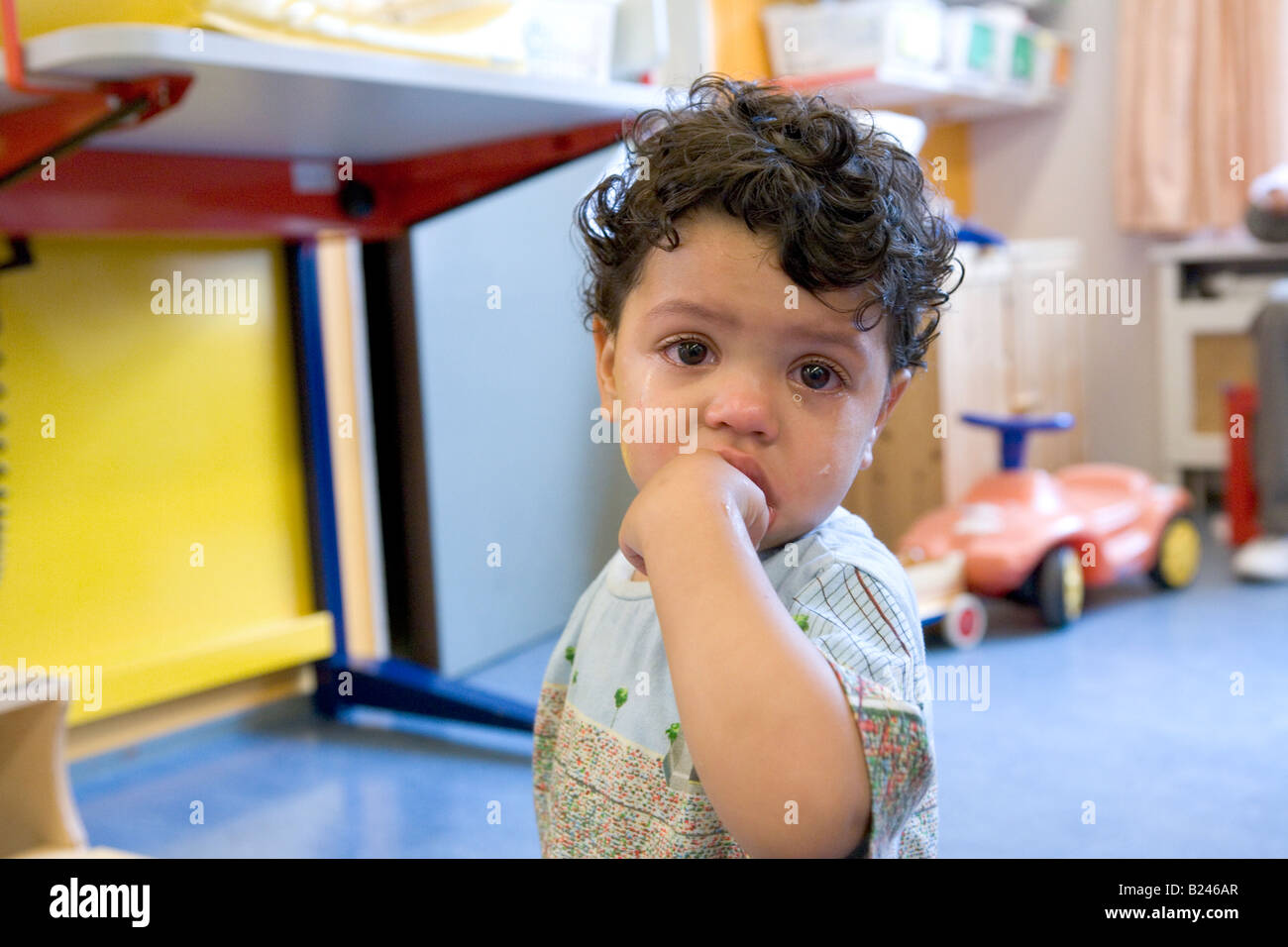 Sad boy in a daycare center Stock Photo Alamy