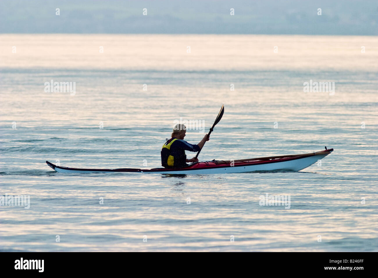Female paddle a kayak at sea Stock Photo