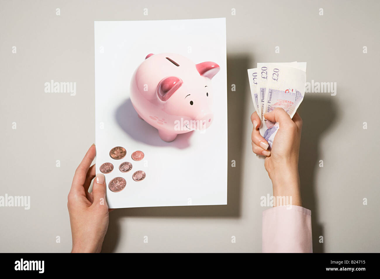 A woman holding a photograph of a piggy bank and money Stock Photo - Alamy