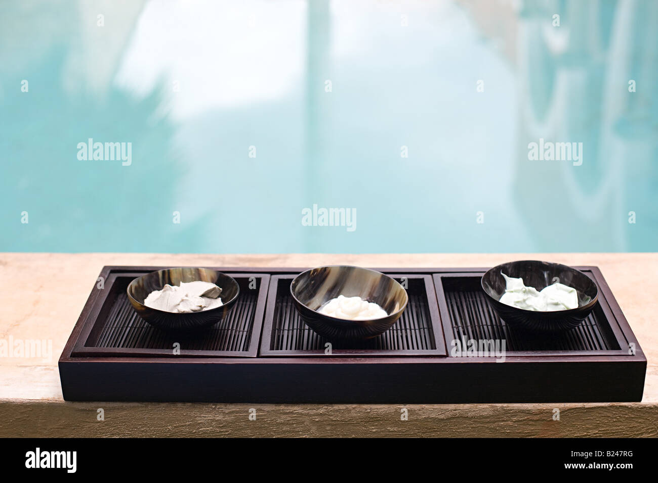 Bowls by swimming pool Stock Photo