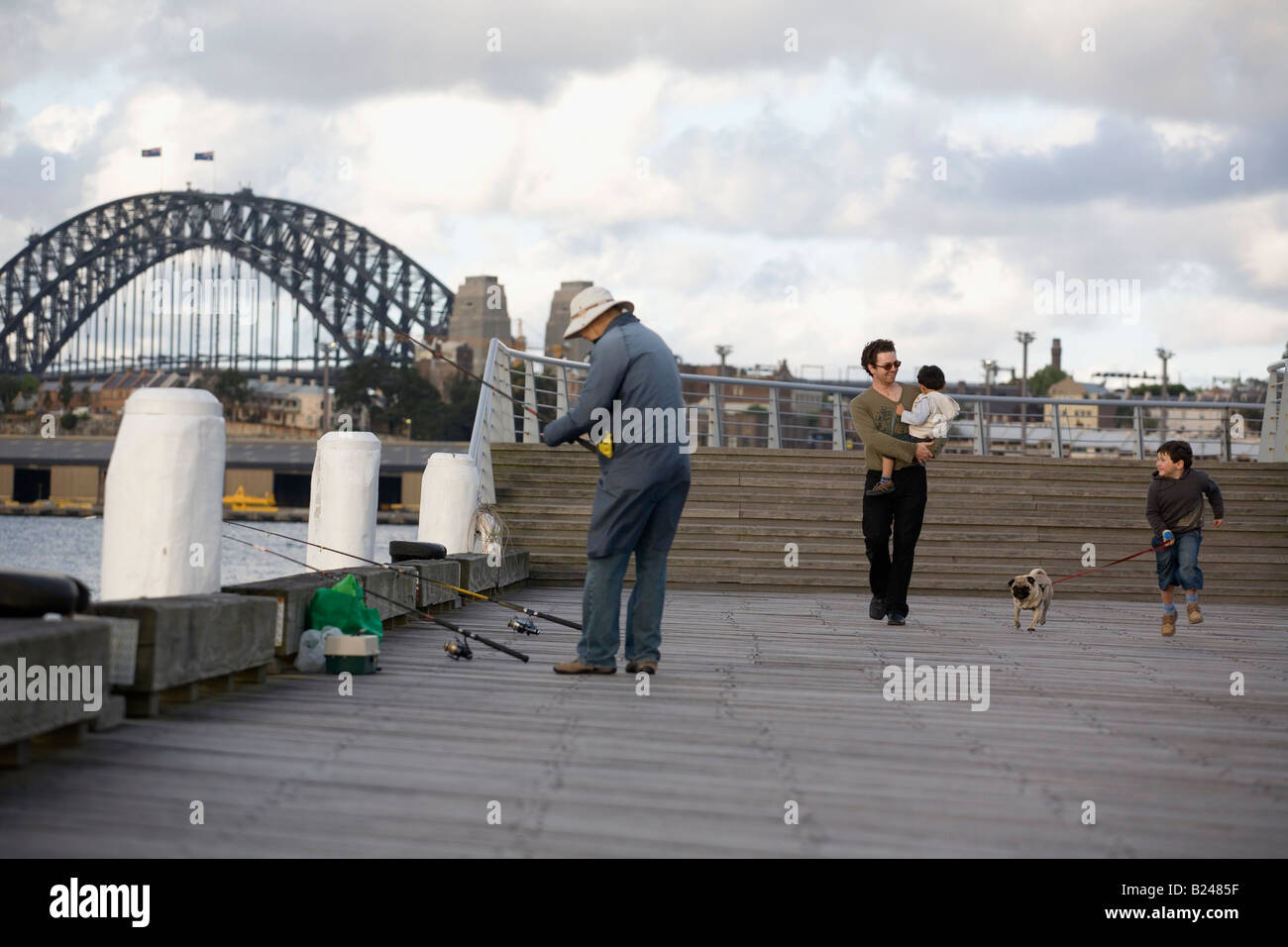 Father and Sons walking the Dog Pyrmont Point Park Sydney New South Wales Australia Stock Photo