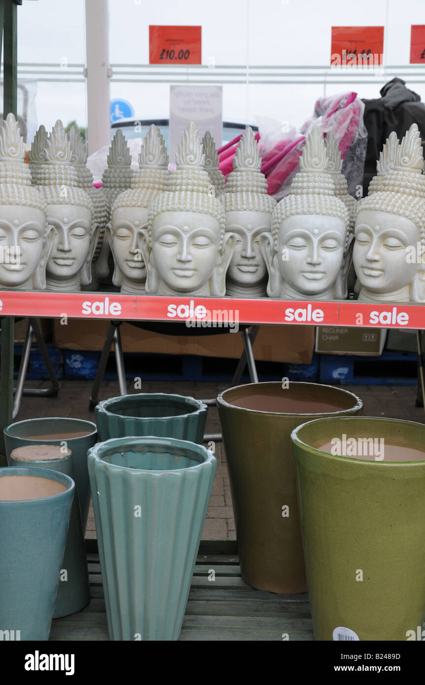 Garden shelves outside Asda with heads of the Buddah for sale Stock