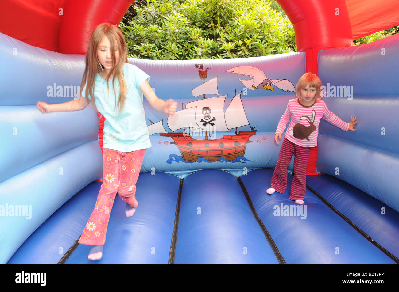 Two children on a bouncy castle Stock Photo