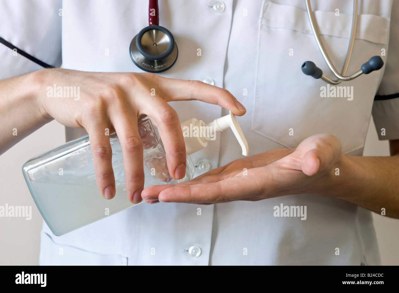 A nurse washing her hands with antibacterial hand gel Stock Photo Alamy