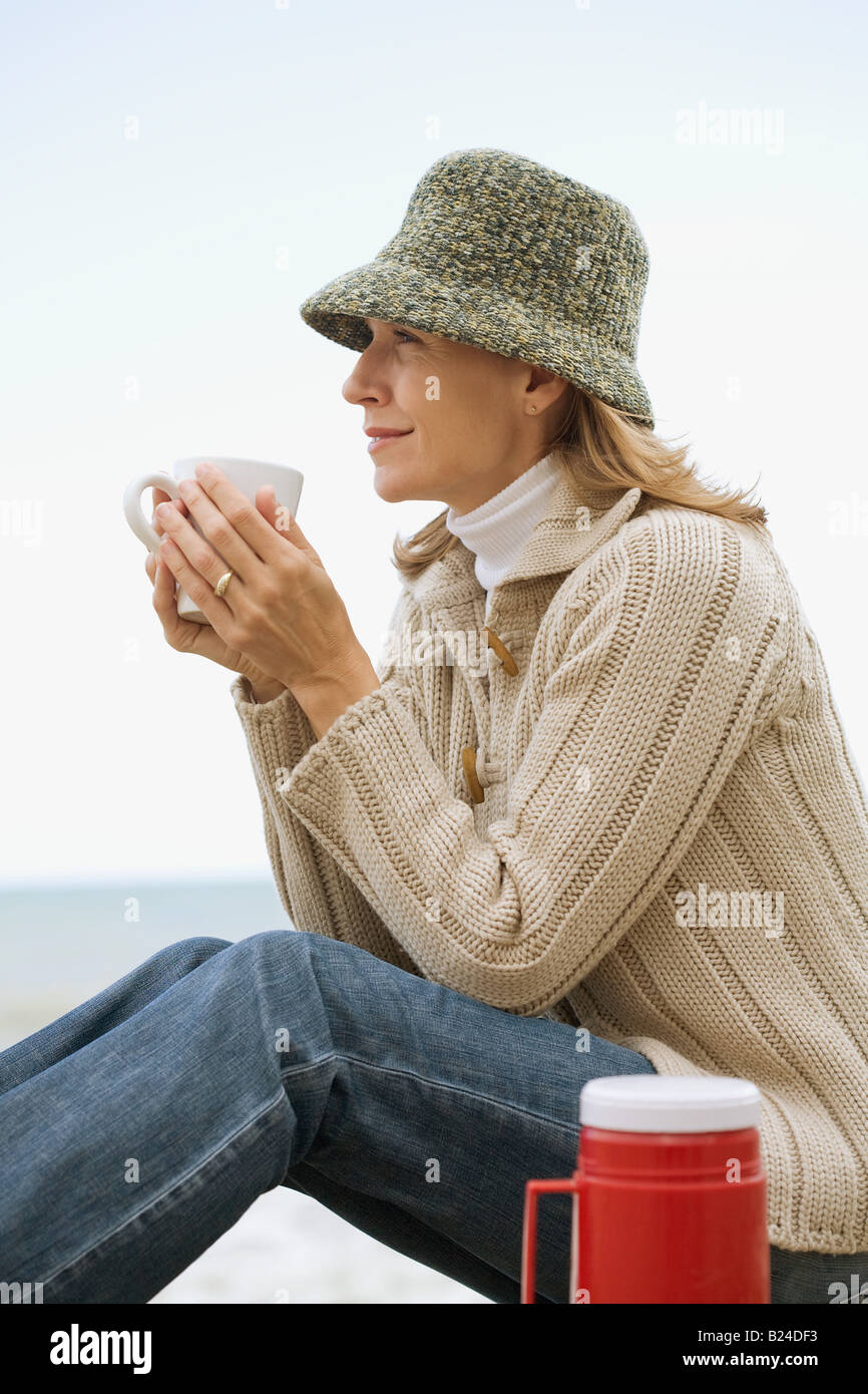 Woman having a hot drink Stock Photo