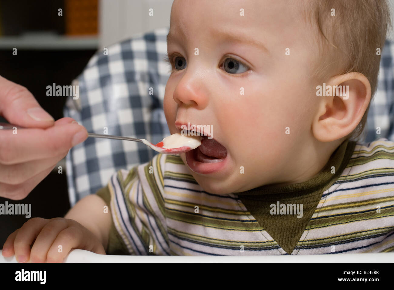 Baby being fed Stock Photo