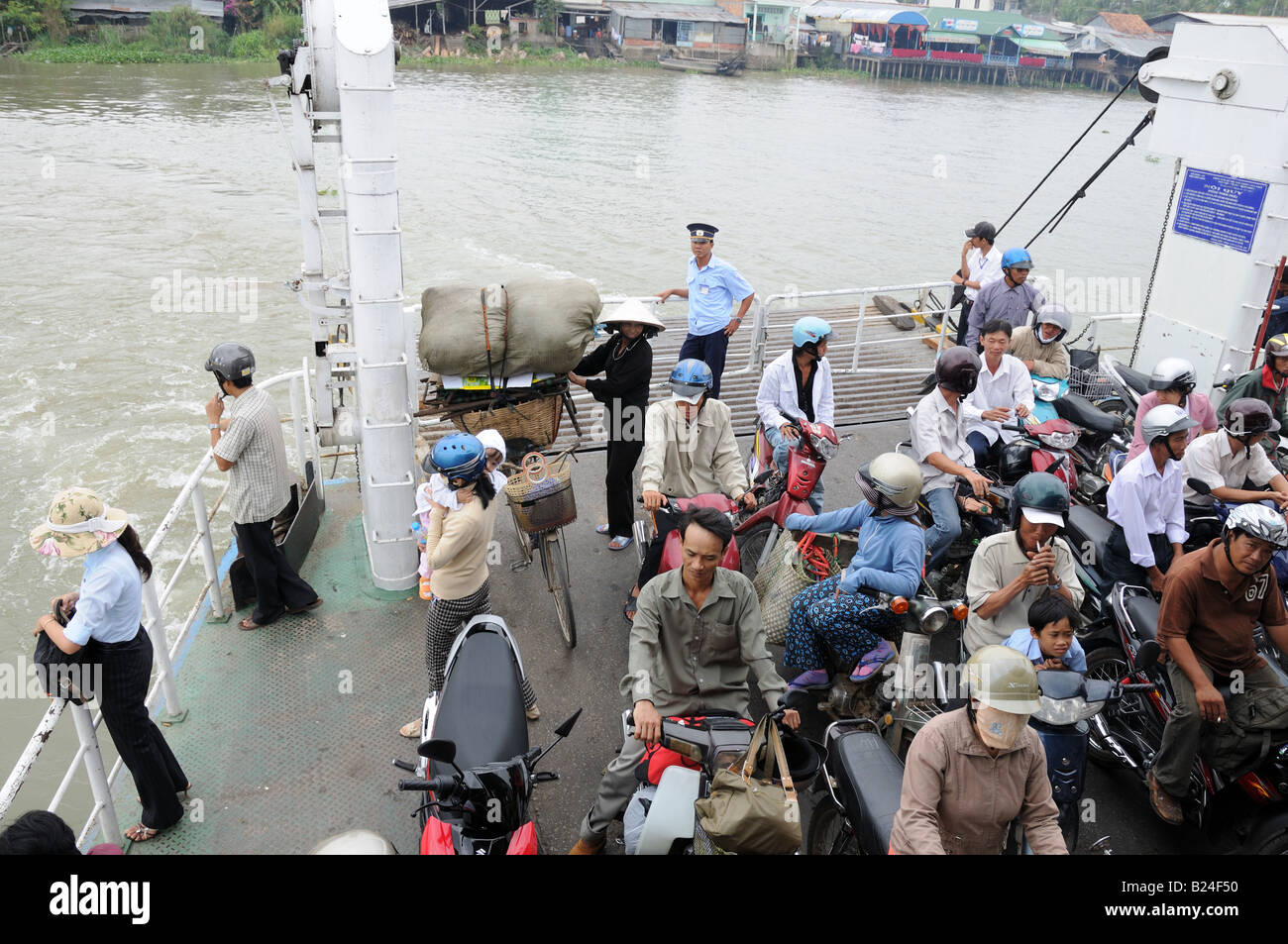 Vietnamese people on a Ferry crossing the Mekong river Vietnam Stock ...