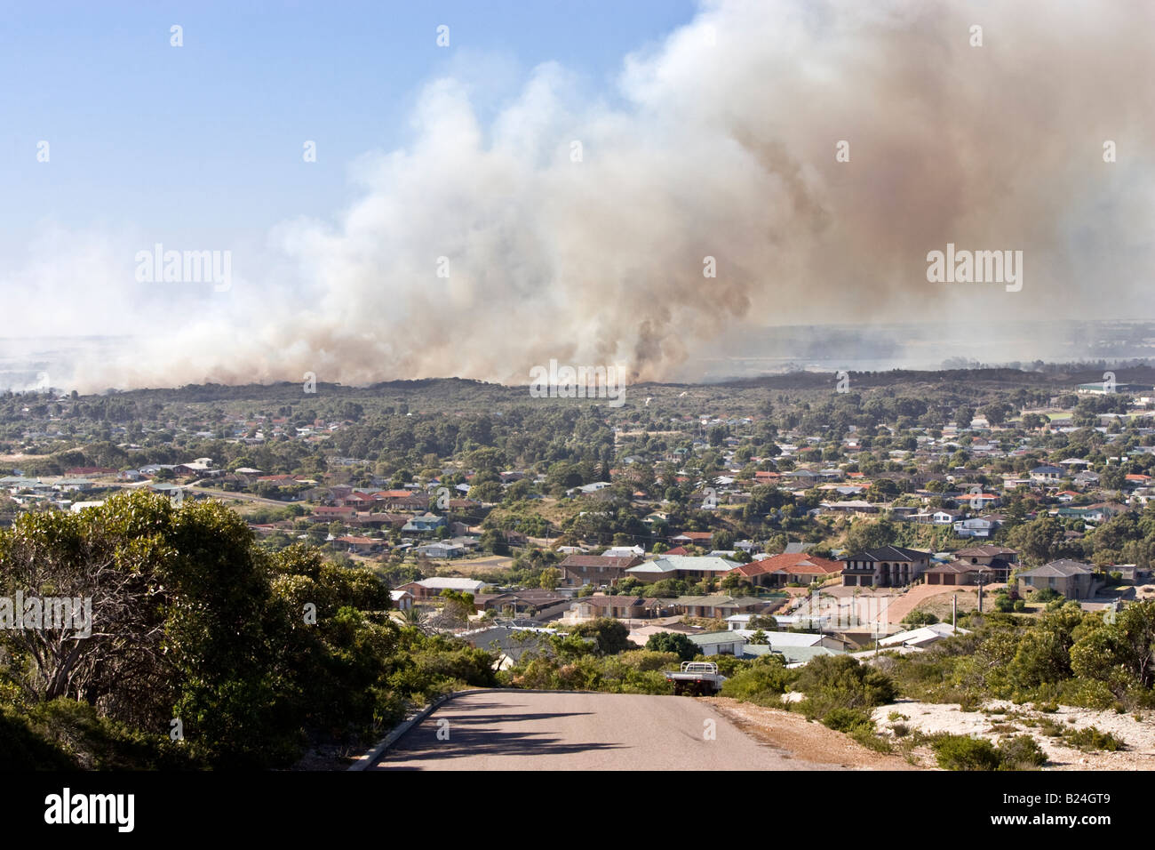 A fire raging in bushland next to houses in the town of Esperance in Western Australia. Stock Photo