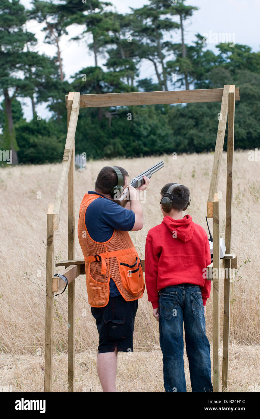 Teaching a young person how to safely use a shotgun for clay pigeon shooting Stock Photo Alamy