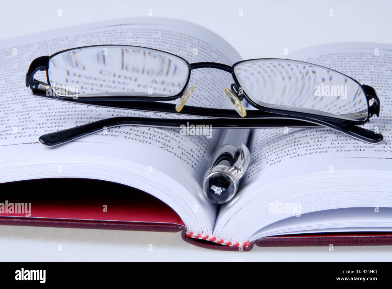 a book with pen and glasses Stock Photo
