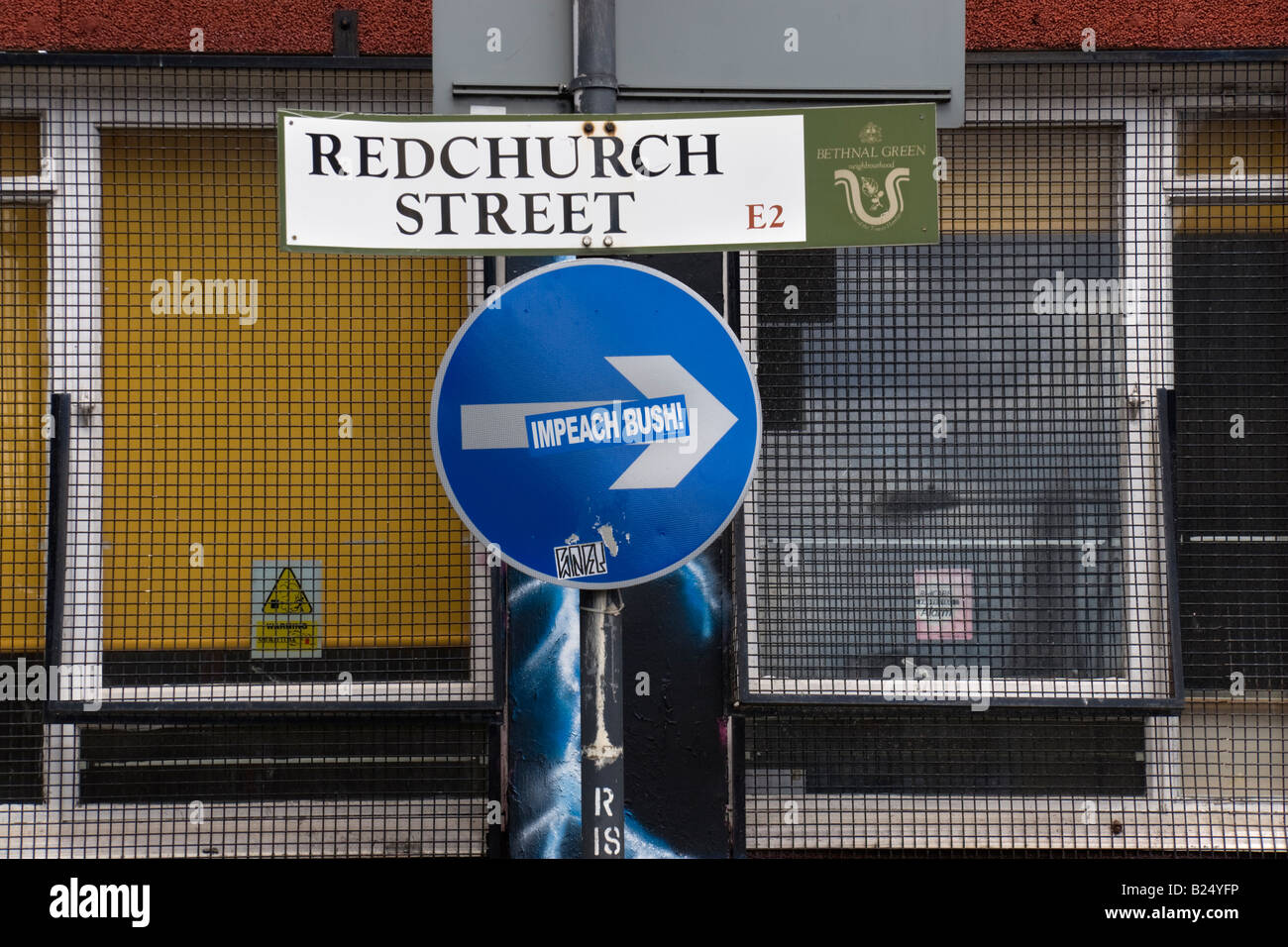 Road sign for Redchurch Street in East London The arrow on a circular blue one way sign on the same signpost is a sticker saying Stock Photo