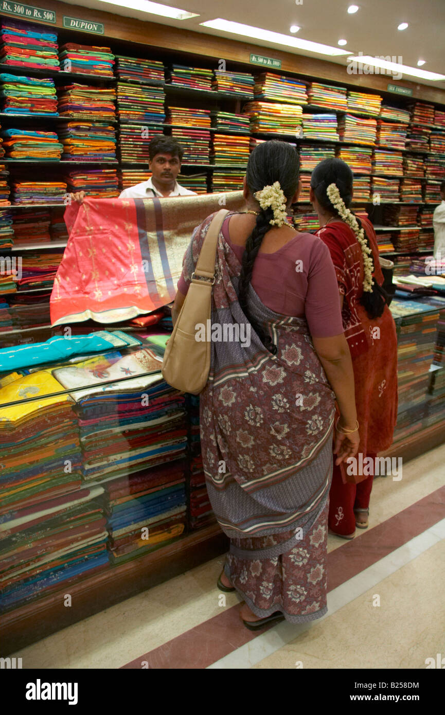 Indian women looking at sarees inside Pothys textile store Panagal Park