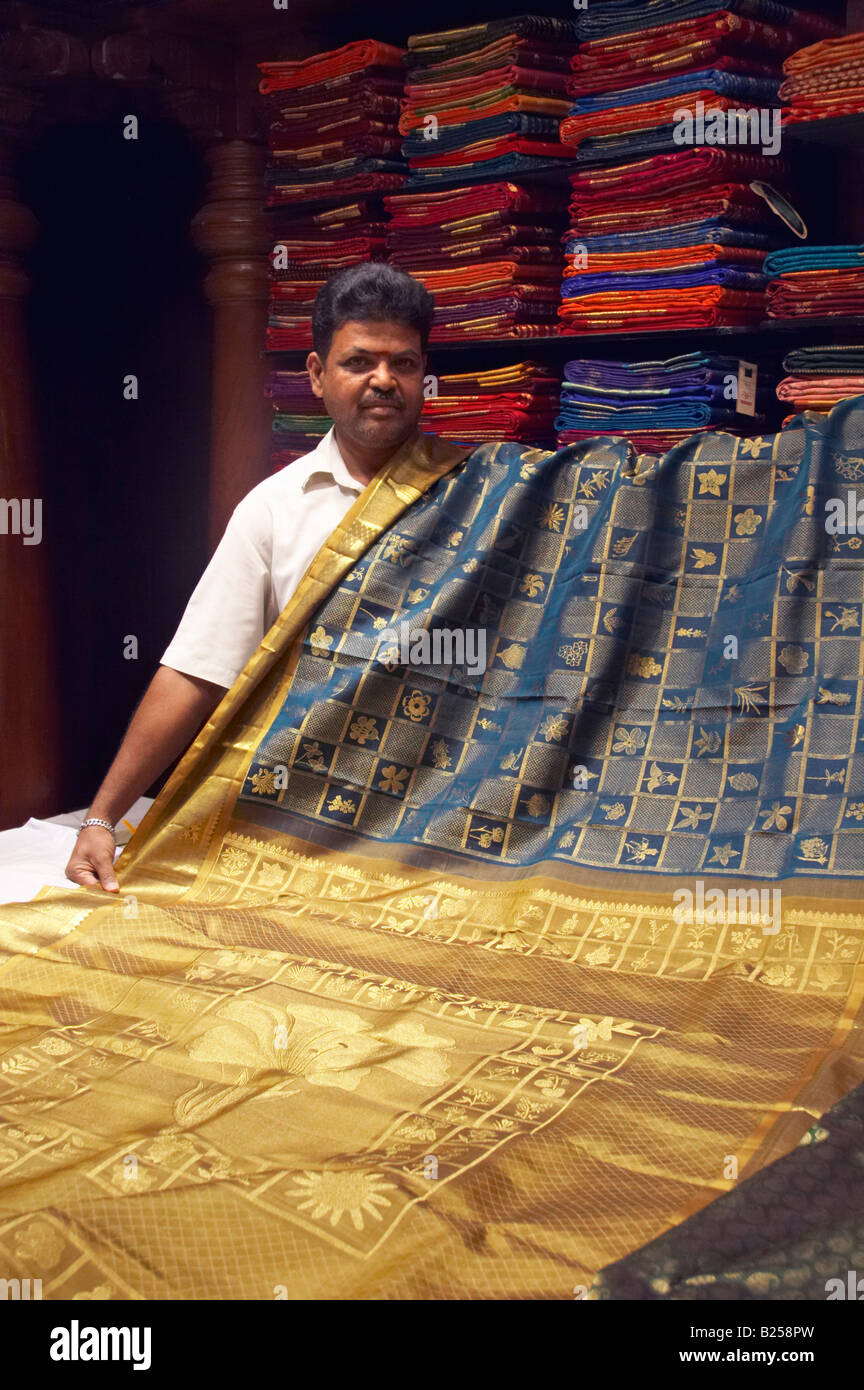 Indian man with luxury silk fabric in Pothys textile store Panagal Park