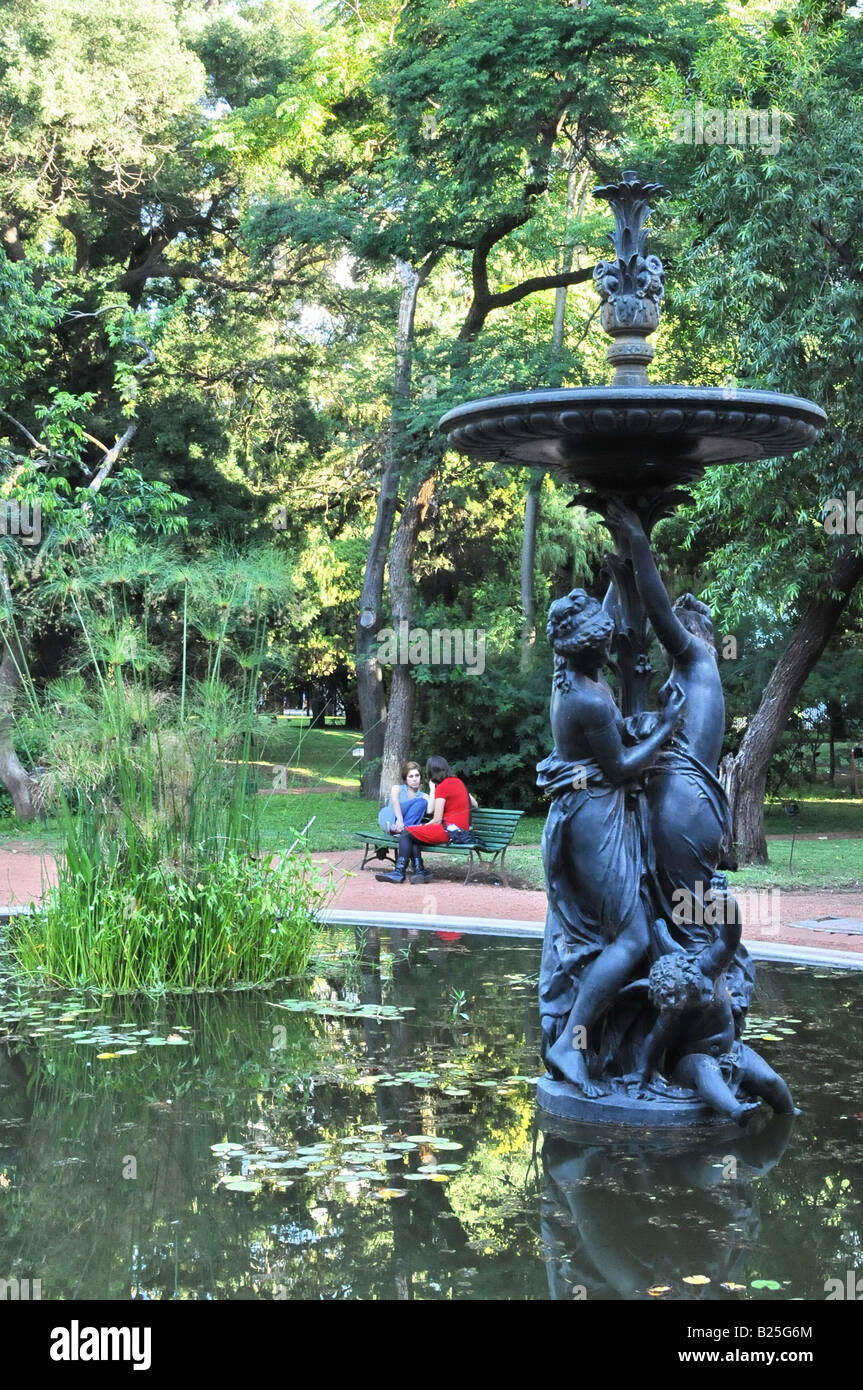 Bronze statue in pond and two women in conversation in Botanical Garden
