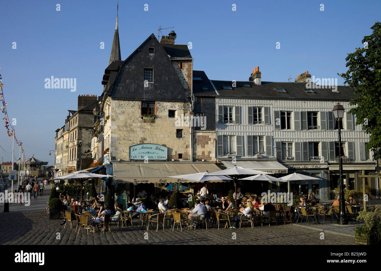 People drinking and dining outside at Honfleur harbour Normandy France Europe Stock Photo
