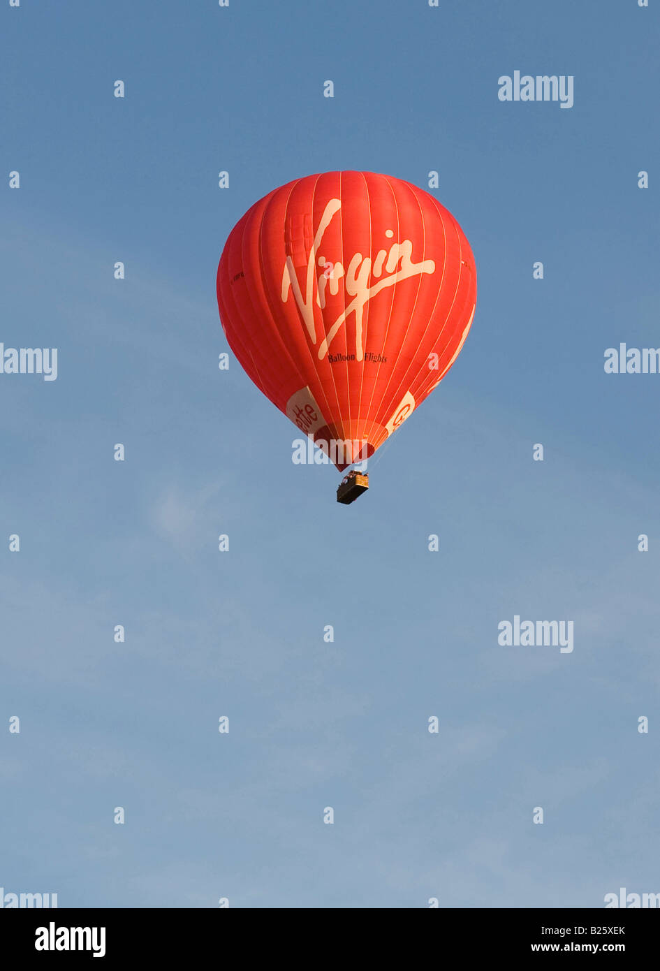 Red Virgin hot air balloon against a clear blue sky with Virgin Logo in