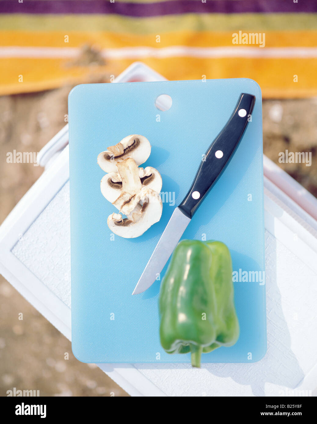 Mushrooms and green pepper on chopping board Stock Photo - Alamy