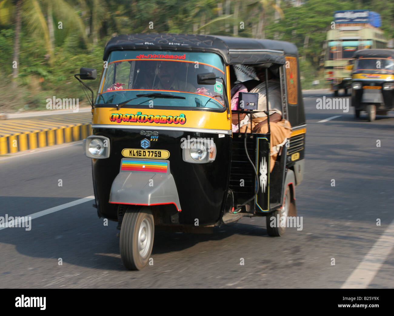 Tricycle auto rickshaw on the National Highway near Attingai Kerala India Stock Photo