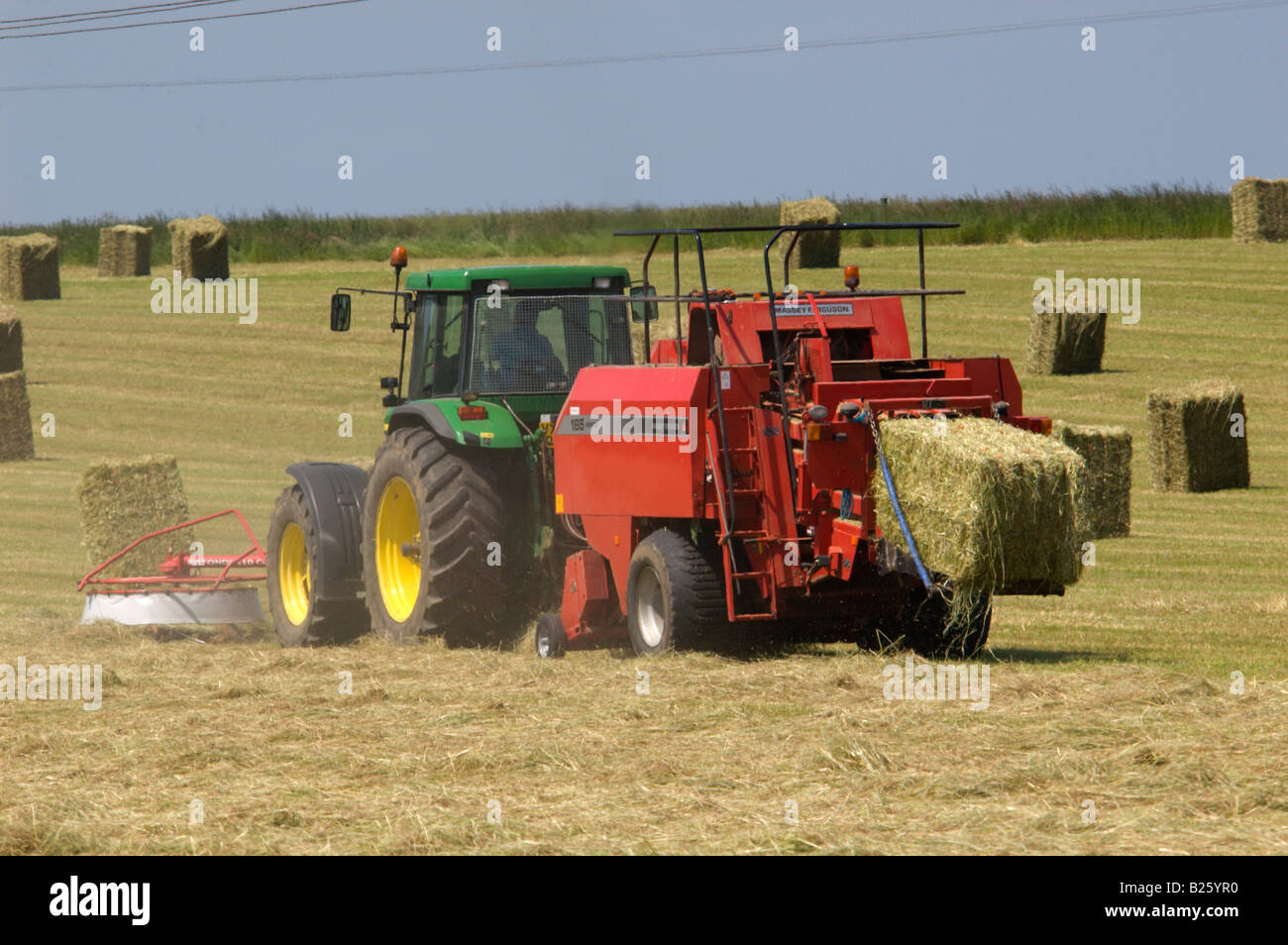 Tractor bailing hay in farm hires stock photography and images Alamy