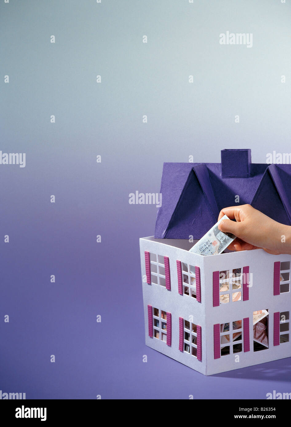 Putting money note into house hi-res stock photography and images - Alamy