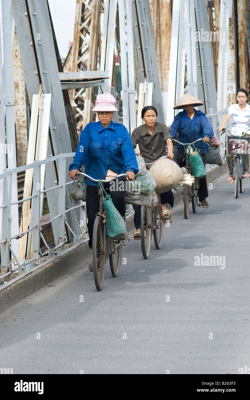Bicycles crossing the Red River in Hanoi on the Long Bien railway bridge Stock Photo
