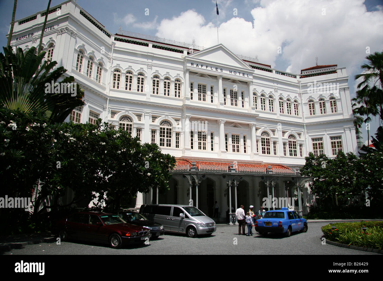 The facade of Raffles Hotel in Singapore. The hotel is the watchword for luxury and service on the island. Stock Photo