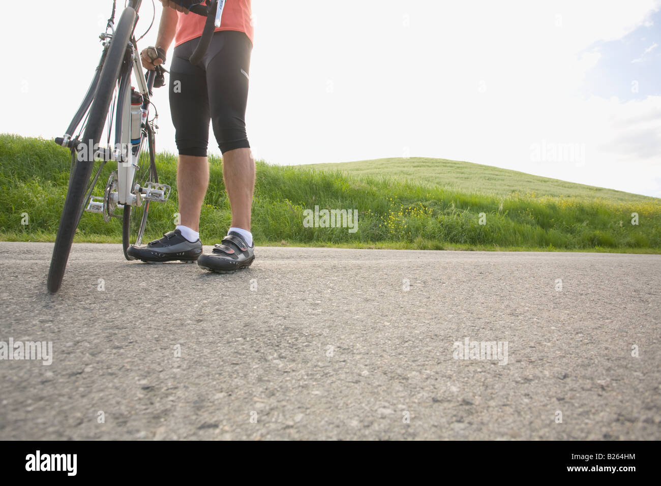 Cyclist with bike, low section Stock Photo