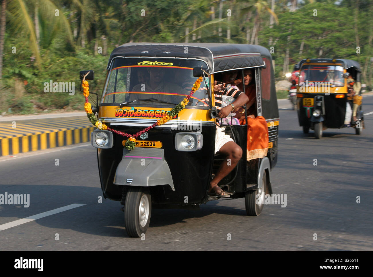 Tricycle auto rickshaw on the National Highway near Attingai Kerala India Stock Photo