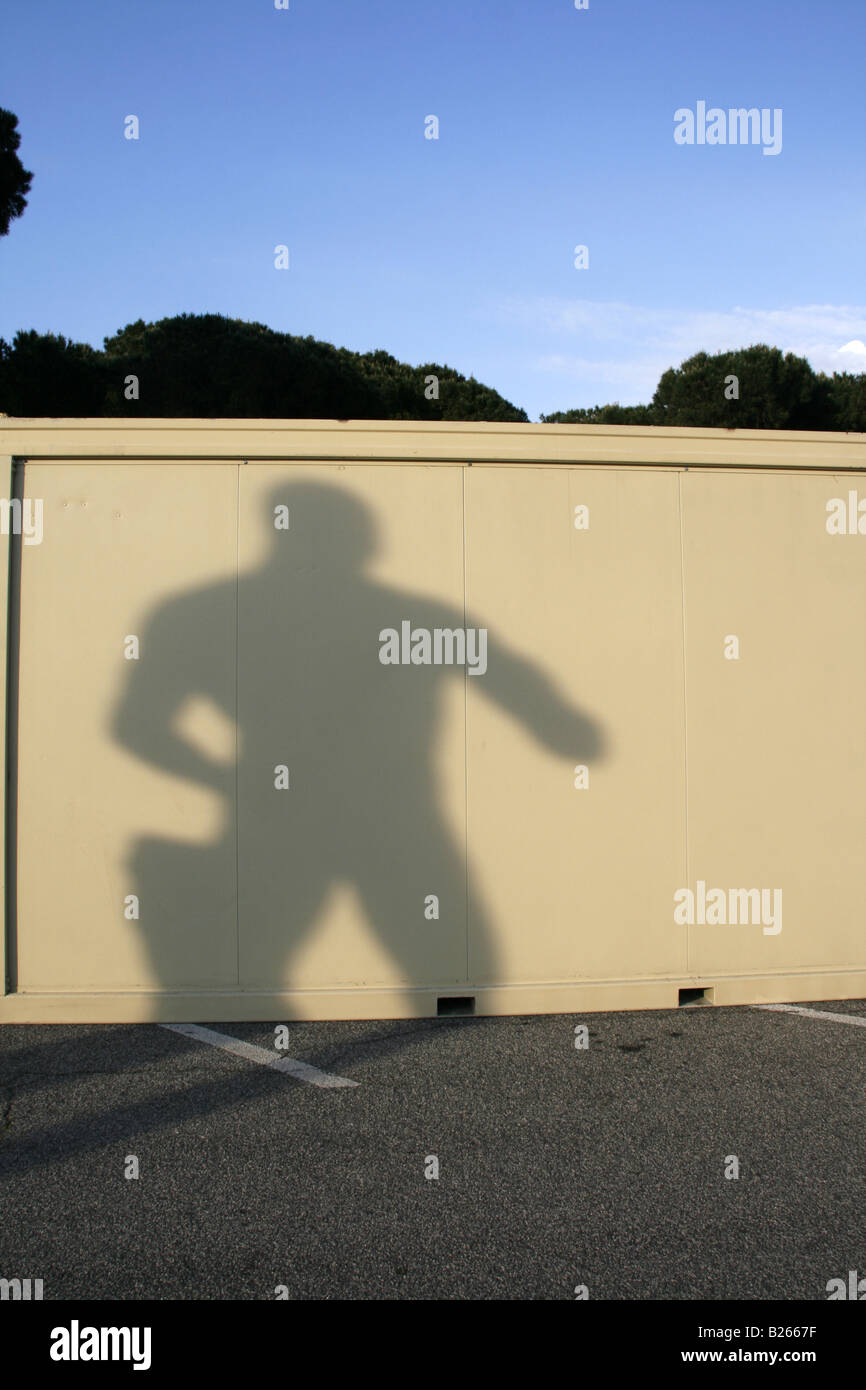 one strong man statue's shadow on portable cabin Stock Photo Alamy
