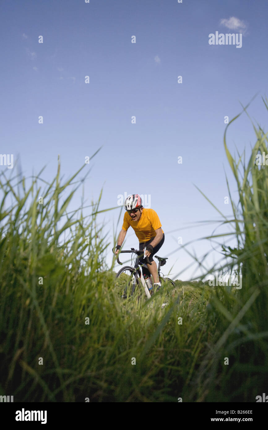 Side view of a man cycling Stock Photo