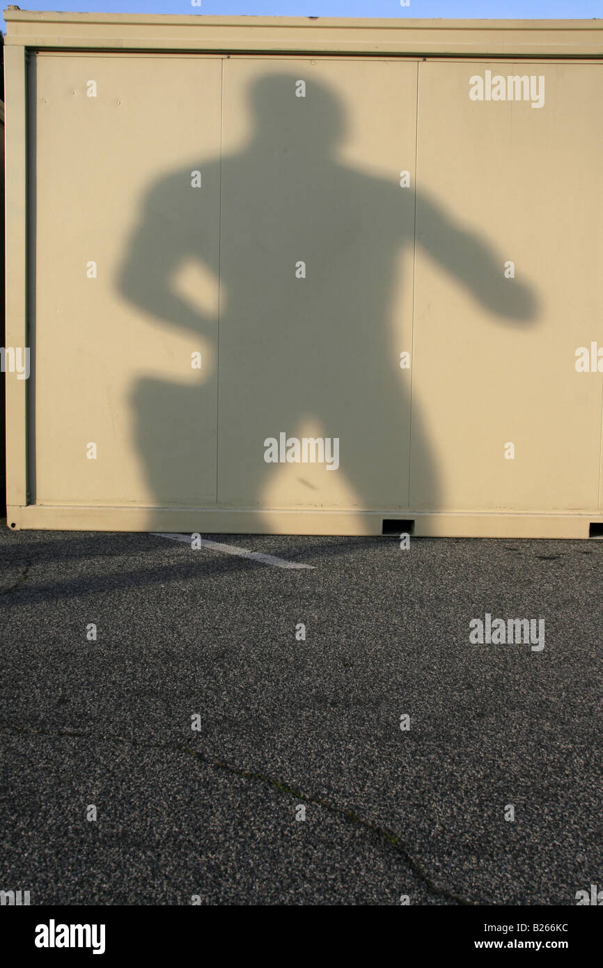 one strong man statue's shadow on portable cabin Stock Photo Alamy