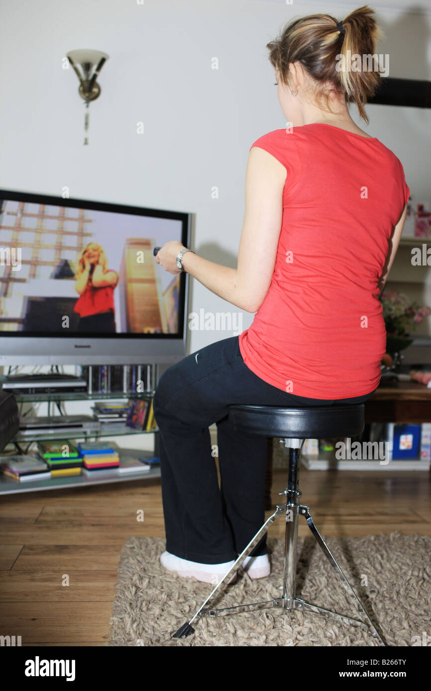 Young Woman watching Television Model Released Stock Photo