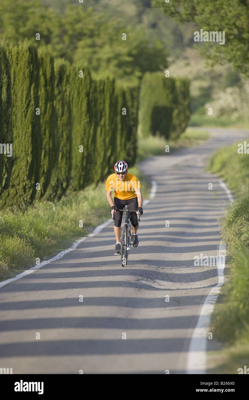 Front view of a man cycling on road Stock Photo
