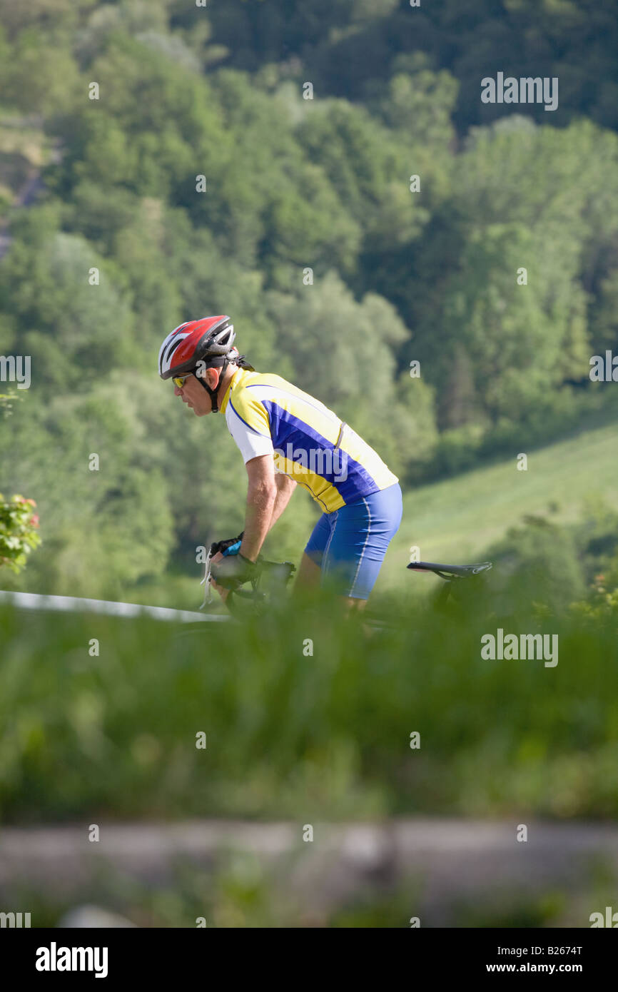 Side view of a man cycling Stock Photo