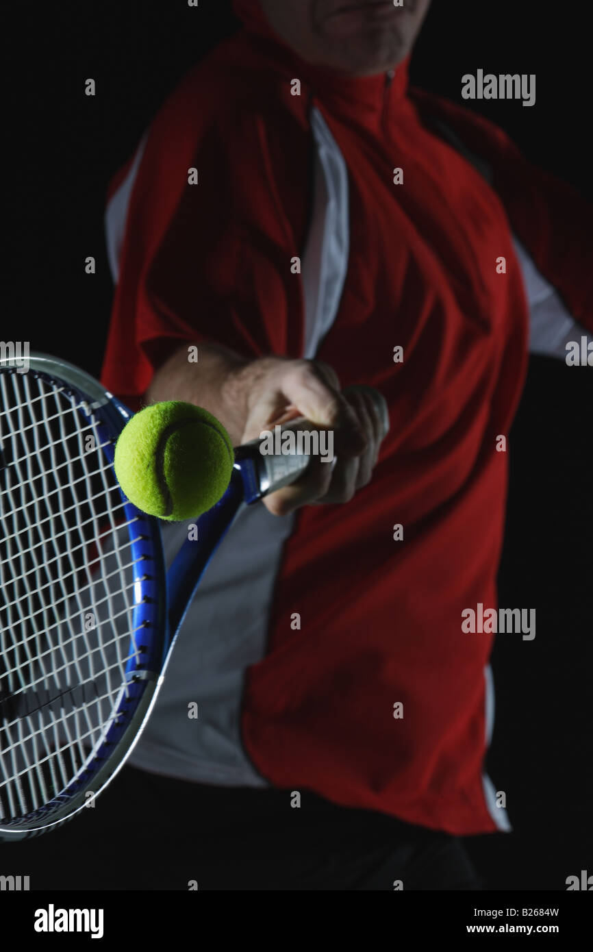 Tennis Player Swinging at Ball Stock Photo