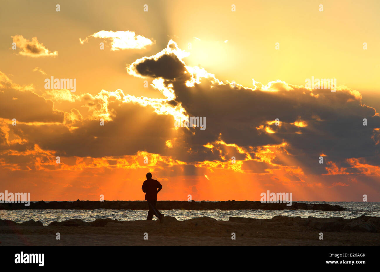 Jogger in sunset, Mediterranean, Tel Aviv, Israel Stock Photo