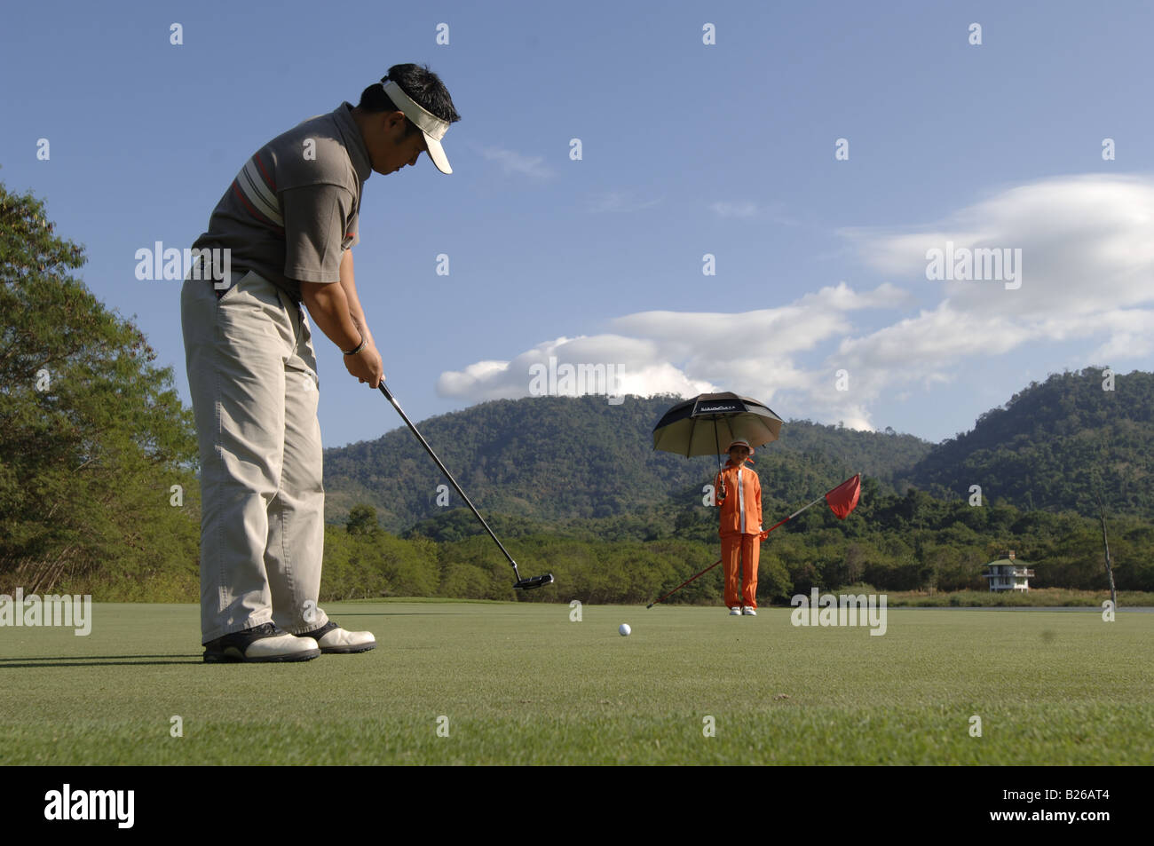 Man playing golf, Golf player and caddy, Kirimaya Golf Course, Khao Yai