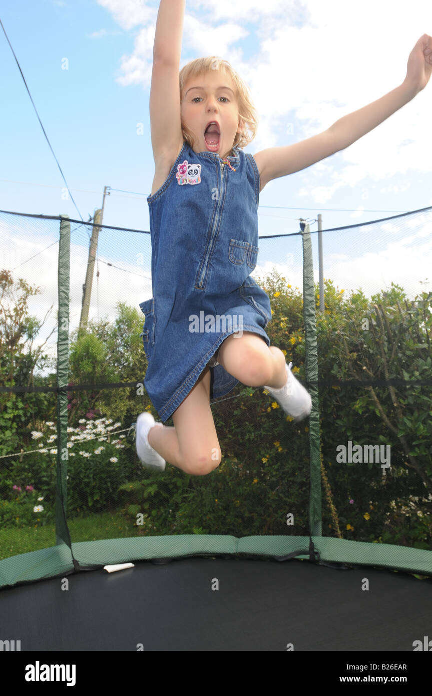 A child bounces on a trampoline Stock Photo - Alamy